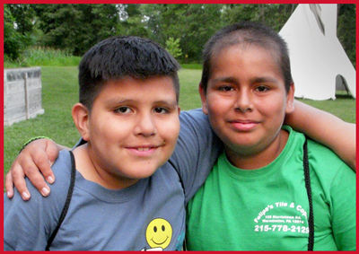 Camp Can DO two friends in front of Indian teepee