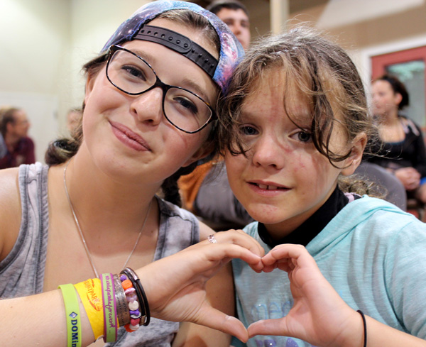 2 Campers make Heart Hands at Camp Can Do